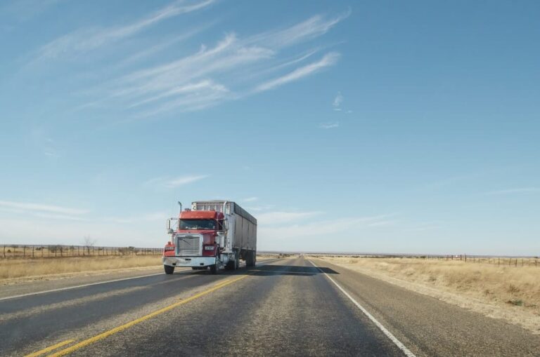 Semi truck driving down a highway.