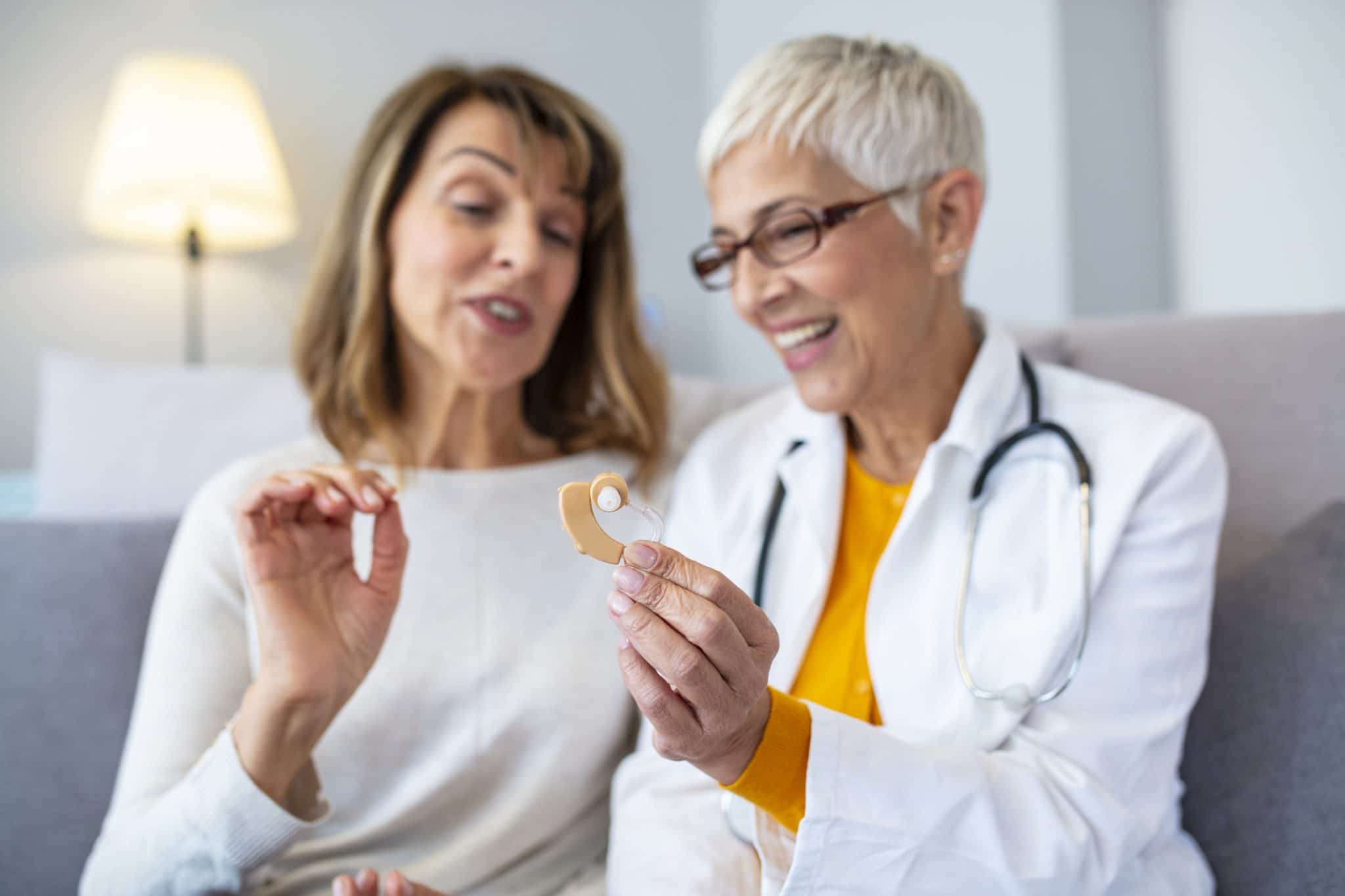 Woman speaks to her audiologist about hearing aids.
