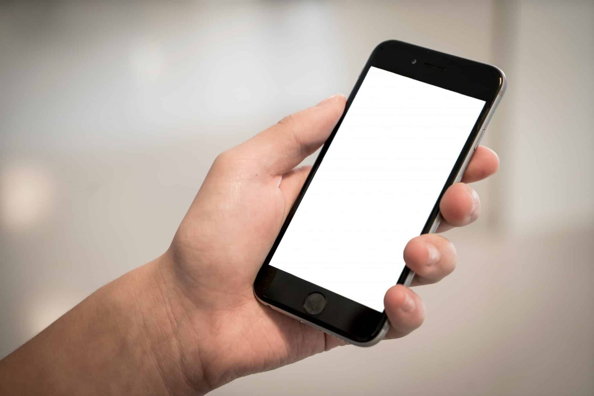 Close-up of person holding iPhone.