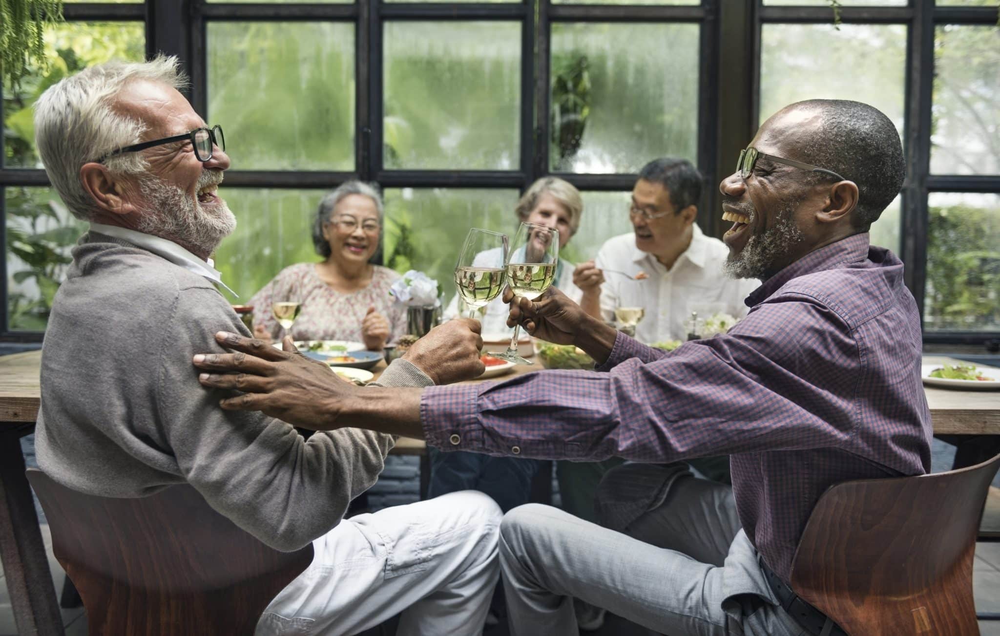 Group of older friends enjoying a meal together.