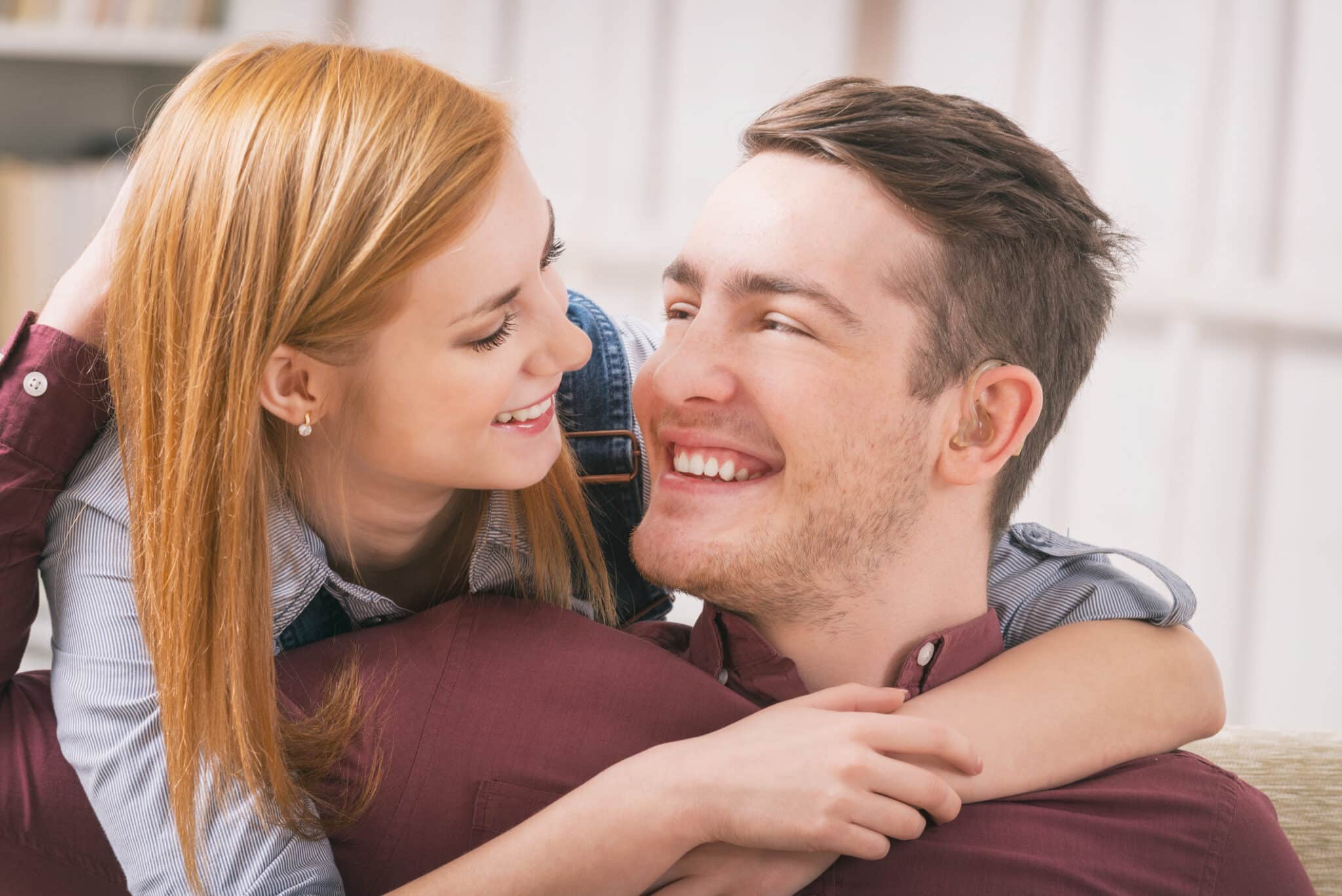 Man with hearing aids spending time with his girlfriend or wife at home.